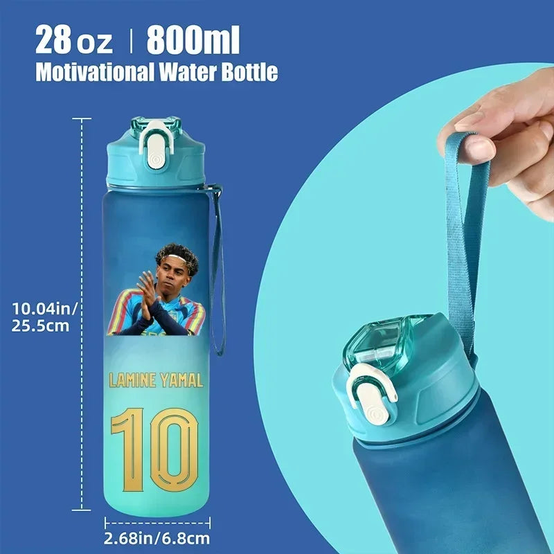 A 28 oz / 800 ml water bottle with a custom player graphic, shown with dimension lines and a hand holding its carrying strap against a blue background.