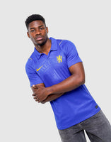 A man wearing a royal blue Nike Chelsea FC 2026/27 Home Shirt, featuring the Chelsea FC crest and a yellow Nike swoosh, posed against a light gray background.