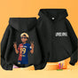 Two black zip-up hoodies shown on a warm orange background: one front view with white 'LAMINO X YIMAL' text on the chest and one back view featuring a cartoon-style player graphic in a blue and red soccer jersey with the number 19.