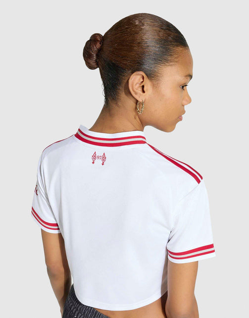 A woman shown from the back wearing a adidas Liverpool FC 26/27 Away Jersey Crop top with red double stripes on the collar and sleeve cuffs, plus a small red logo near the upper back, against a light gray studio background.